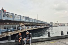 Locals talking under Karakoy Pier in the historic center of Istanbul.